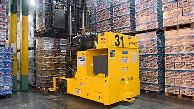 A smart cart is shown moving a pallet of beverages.