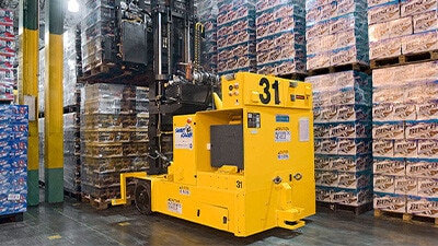 A smart cart is shown moving a pallet of beverages.