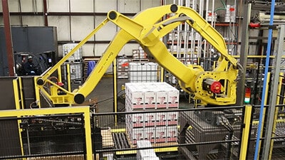 A palletizing robot stacks cartons on a pallet.