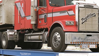 A semi truck is shown on an Avery Weigh-Tronix scale.