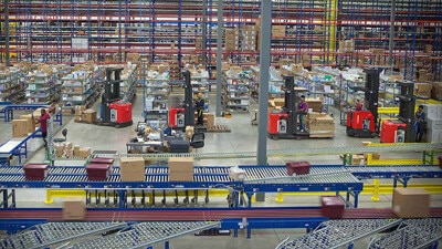 Boxes are shown moving on a conveyor belt in a warehouse.