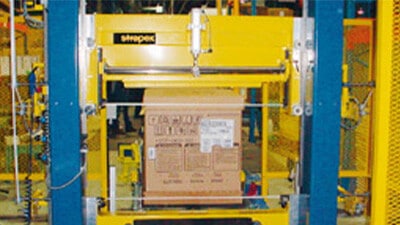 An Endra strapping machine is shown putting straps on a carton.