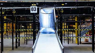 A gravity conveyor is shown in a warehouse.