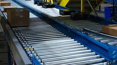 Cartons are shown on a live roller conveyor.