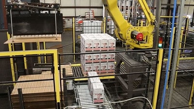 A palletizing robot is shown stacking cartons on a pallet.