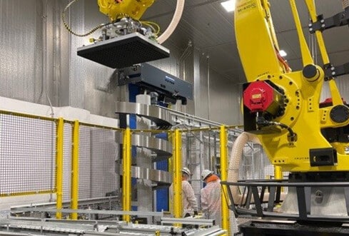 A robotic depalletizer in a food and beverage processing plant.