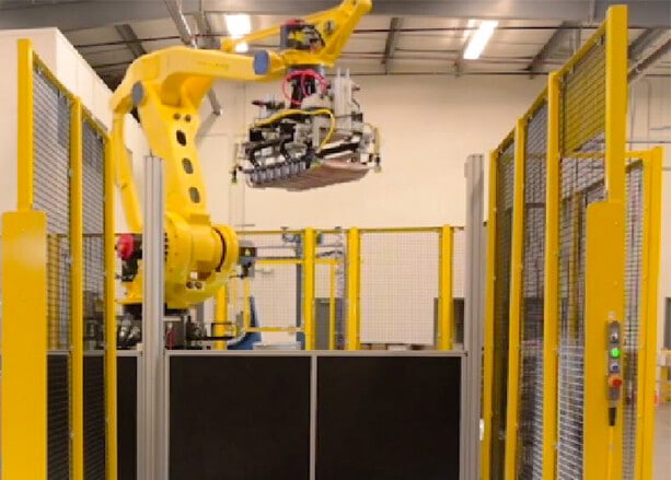 A palletizing robot moves materials in a facility.