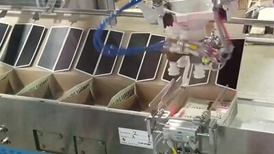 A robotic welder works on a production line.