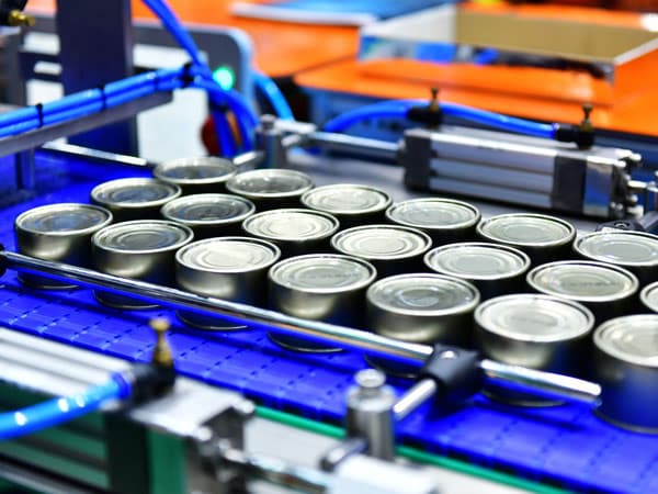 Cans ready to be put on a pallet by a robotic can palletizer.