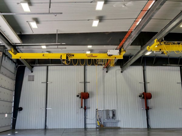 An underhung crane is shown in a shop.